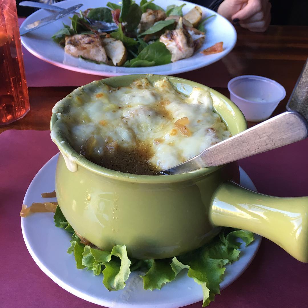 Freddys French Onion Soup is pretty badass Thats a Spinach Pear  Gorgonzola salad in the backgroundwe recommend the apple cider vinaigrette dressing